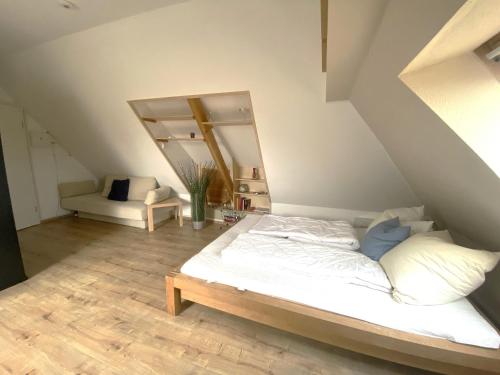 a bedroom with a white bed and a mirror at An de Bäk Bornstübchen in Born