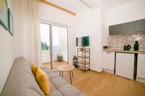 a living room with a couch and a kitchen at The Rooftop of Apartments Lungo Mare in Ulcinj