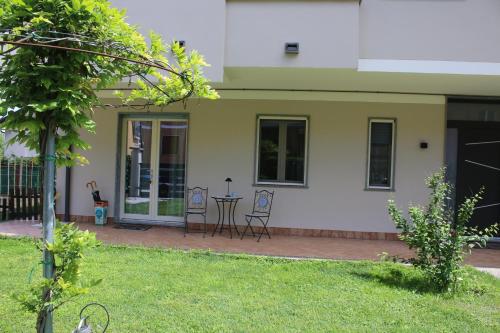 a patio with chairs and a table in front of a house at L'alba di Langa in Narzole