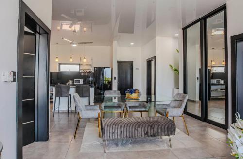 a dining room with a glass table and chairs at Instyle Residences at RIZZ SUITES in Sosúa