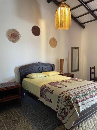 a bedroom with a bed and a chandelier at Un Dia Boutique Resort in Playas