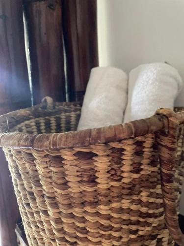 a wicker basket sitting on a table with towels at Un Dia Boutique Resort in Playas