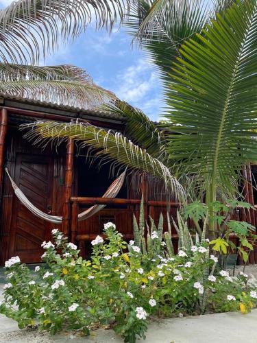 a house with a bunch of flowers in front of it at Un Dia Boutique Resort in Playas