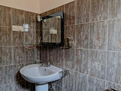 a bathroom with a sink and a mirror at Serendip Villa Holiday Home Talalla Sri Lanka in Talalla