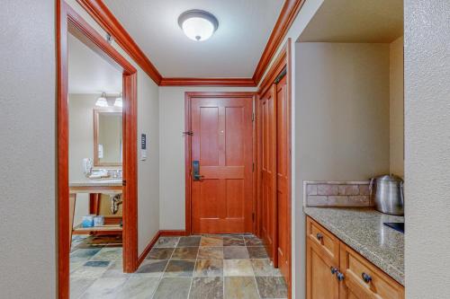 a kitchen with a wooden door and a sink at Resort at Squaw Creek's 605 in Olympic Valley