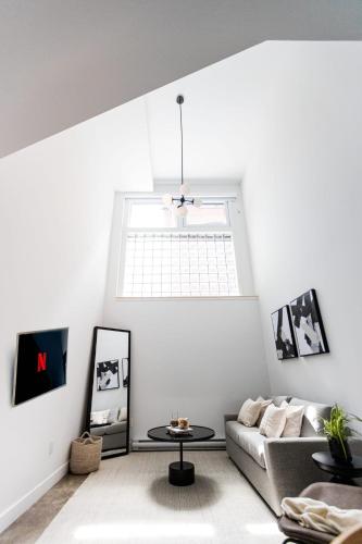 a living room with a couch and a table at Le Mile End by M11 - Modern Luxe 1BDR with Sofa Bed in Montréal