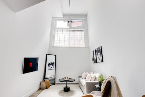 a living room with a couch and a window at Le Mile End by M11 - Modern Luxe 1BDR with Sofa Bed in Montréal