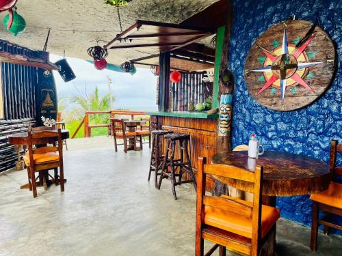 a restaurant with tables and chairs and a bar at Un Dia Boutique Resort in Playas