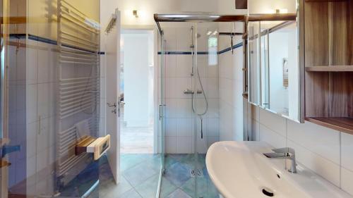 a bathroom with a sink and a shower at Feriendorf Südstrand Haus 23 in Pelzerhaken