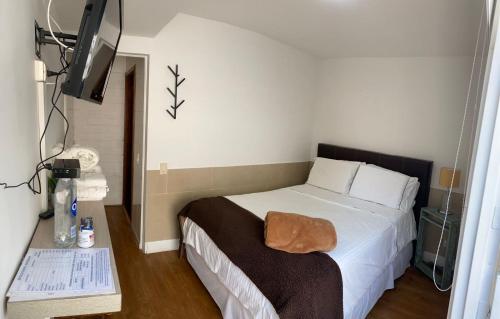 a bedroom with a bed and a television in it at Hotel Casa Madero in Envigado