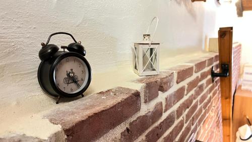 a clock on the side of a brick wall at Cave house in Heraklio Town