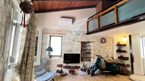 a living room with a stone wall at Cave house in Heraklio Town