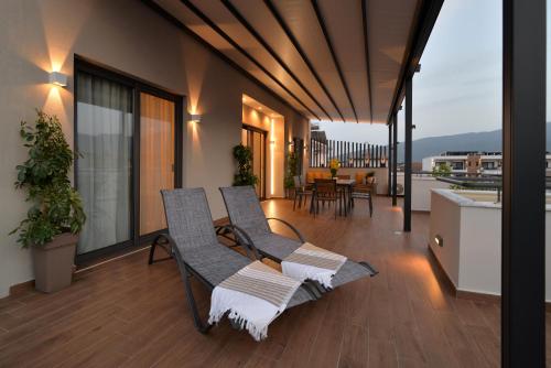 a balcony with two chairs and a table at Irida Apartments in Leptokaria