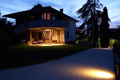 a house with lights on the front of it at Il Melograno - San Quirico d'Orcia in San Quirico dʼOrcia