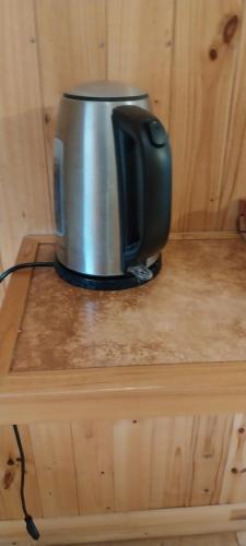 a coffee pot sitting on top of a wooden table at Cabañas Rancho Pinares in Pichilemu