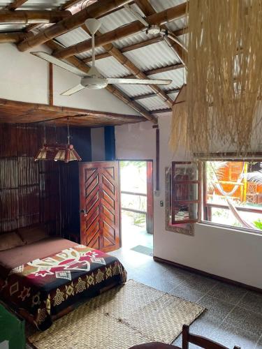 a bedroom with a bed in a room with a door at Un Dia Boutique Resort in Playas