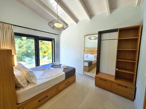 a bedroom with a bed and a large mirror at Anmaria Luxury in Lefkada