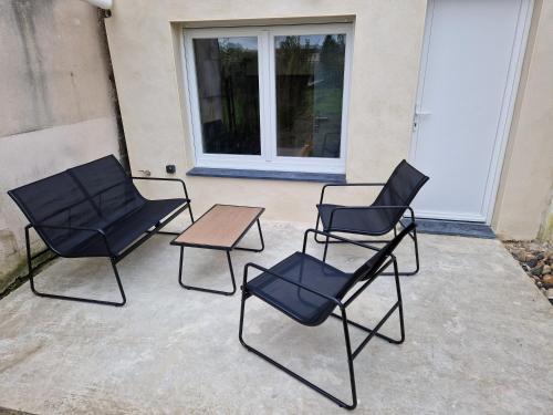a group of chairs and a table on a patio at maison cosy centre-ville in Lens