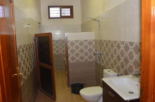 a bathroom with a shower and a toilet and a sink at VillaAbrajeimmo in Marrakech