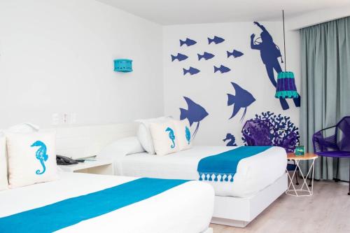 Ein Bett oder Betten in einem Zimmer der Unterkunft Fontan Ixtapa