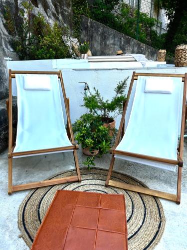 two wooden tables sitting on top of a rug at D'Oliva Gerês - River Side Houses in Geres