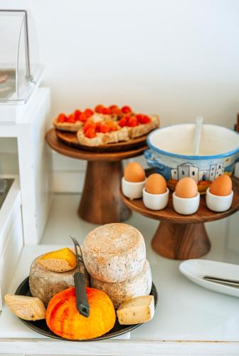 a plate of food with eggs and bread on a counter at Hotel La Madonnina in Ischia