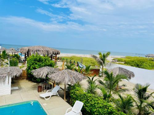 a resort with a pool and chairs and umbrellas at Un Dia Boutique Resort in Playas