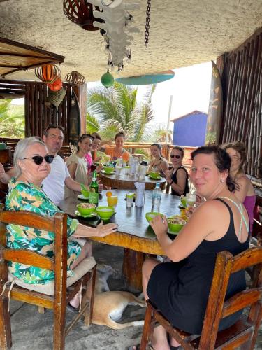 a group of people sitting at a table in a restaurant at Un Dia Boutique Resort in Playas