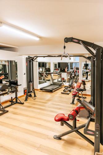 a gym with a bunch of treadmills and machines at Hotel La Madonnina in Ischia