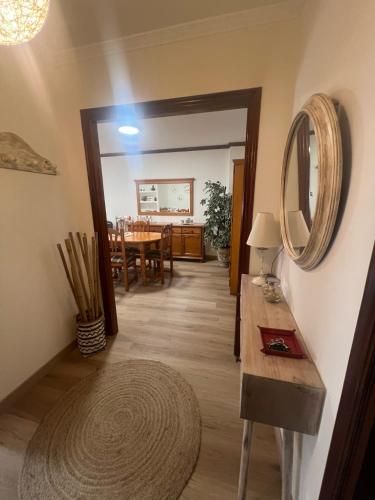 a hallway with a table and a mirror on the wall at Puerto de Bueu, Centro in Bueu
