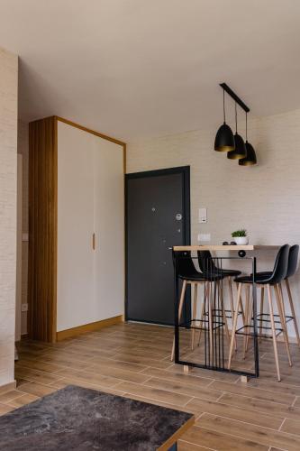 a kitchen with a table and chairs in a room at Apartman Ombra in Veliko Gradište