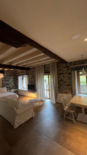 a large living room with a couch and a table at Izal Landetxea - Izal Casa Rural in Bergara
