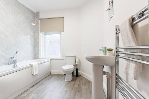 a white bathroom with a toilet and a sink at Herschell House - Central Location - Free Parking, Fast Wifi, SmartTV with Netflix - Perfect for Contractors, Families and Groups by Yoko Property in Redcar