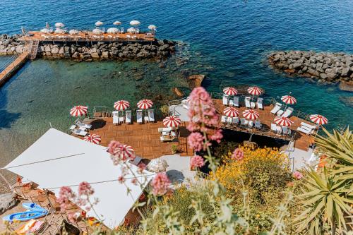 an aerial view of a resort on the water at Hotel La Madonnina in Ischia