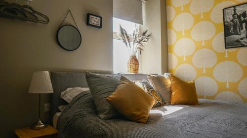 a bedroom with a couch with pillows on it at The Star in Narberth in Narberth