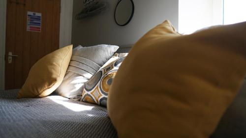 a bed with a bunch of pillows on it at The Star in Narberth in Narberth