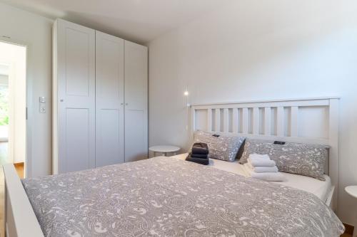 a bedroom with a large bed with white cabinets at Kleine Robbe in Böhl