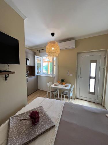 a bedroom with a table and a dining room at Studio apartman Mia in Murter