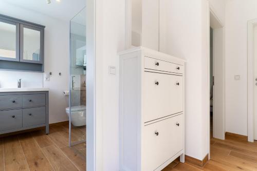 a bathroom with a white cabinet and a sink at Kleine Robbe in Böhl