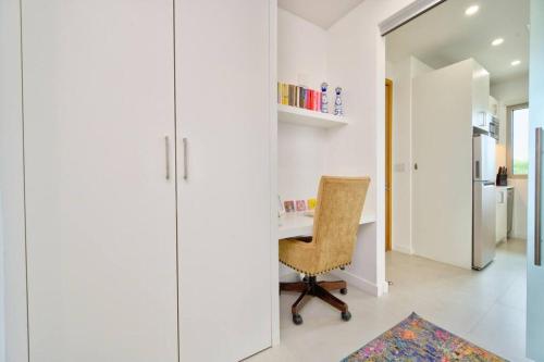 a home office with a desk and a chair at Luxury Condo at Harbour Walk in Red Bay Estate