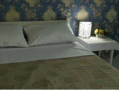 Postel nebo postele na pokoji v ubytování Chomdao Hotel