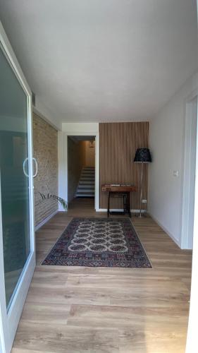 an empty room with a table and a rug at Magnolia 41 in Possagno