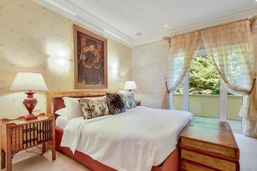 a bedroom with a large bed and a window at Villa ITO in La Spezia