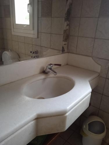 a bathroom with a white sink and a mirror at Alegria house with gardens near portoheli in Kranidi