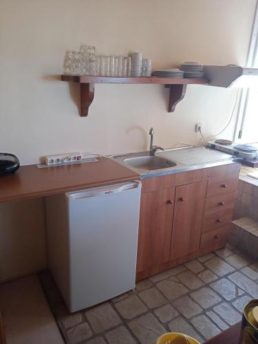 a small kitchen with a sink and a dishwasher at Alegria house with gardens near portoheli in Kranidi