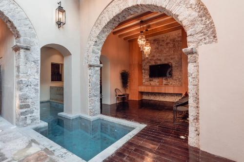 an indoor pool in a home with an archway at Le Cottage San Miguel de Allende, Modern Luxury in Centro with Pool & Jacuzzi in San Miguel de Allende