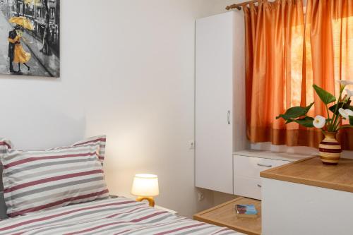 a bedroom with a bed with a striped pillow and a window at Luma Retreat Jacuzzi & Peaceful Rides in Petrača