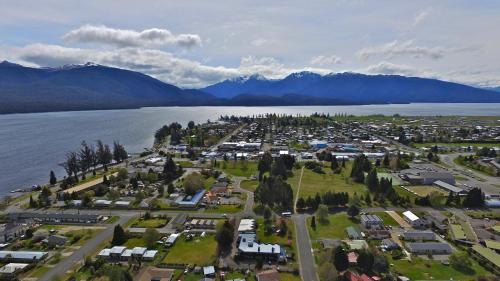 an aerial view of a town next to a body of water at ASURE Explorer Motel & Apartments in Te Anau