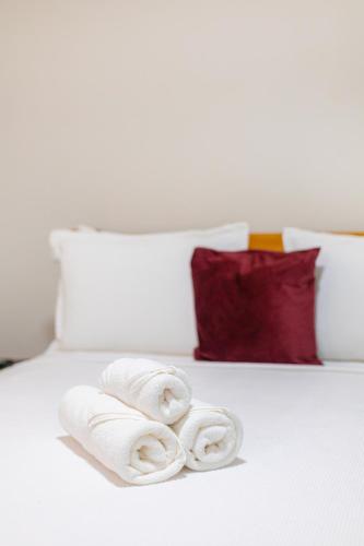 a bed with two rolled towels on it at Pousada Meia Lua in Pirenópolis