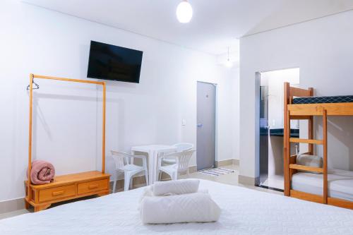 a bedroom with a bed and a table and chairs at Pousada Meia Lua in Pirenópolis
